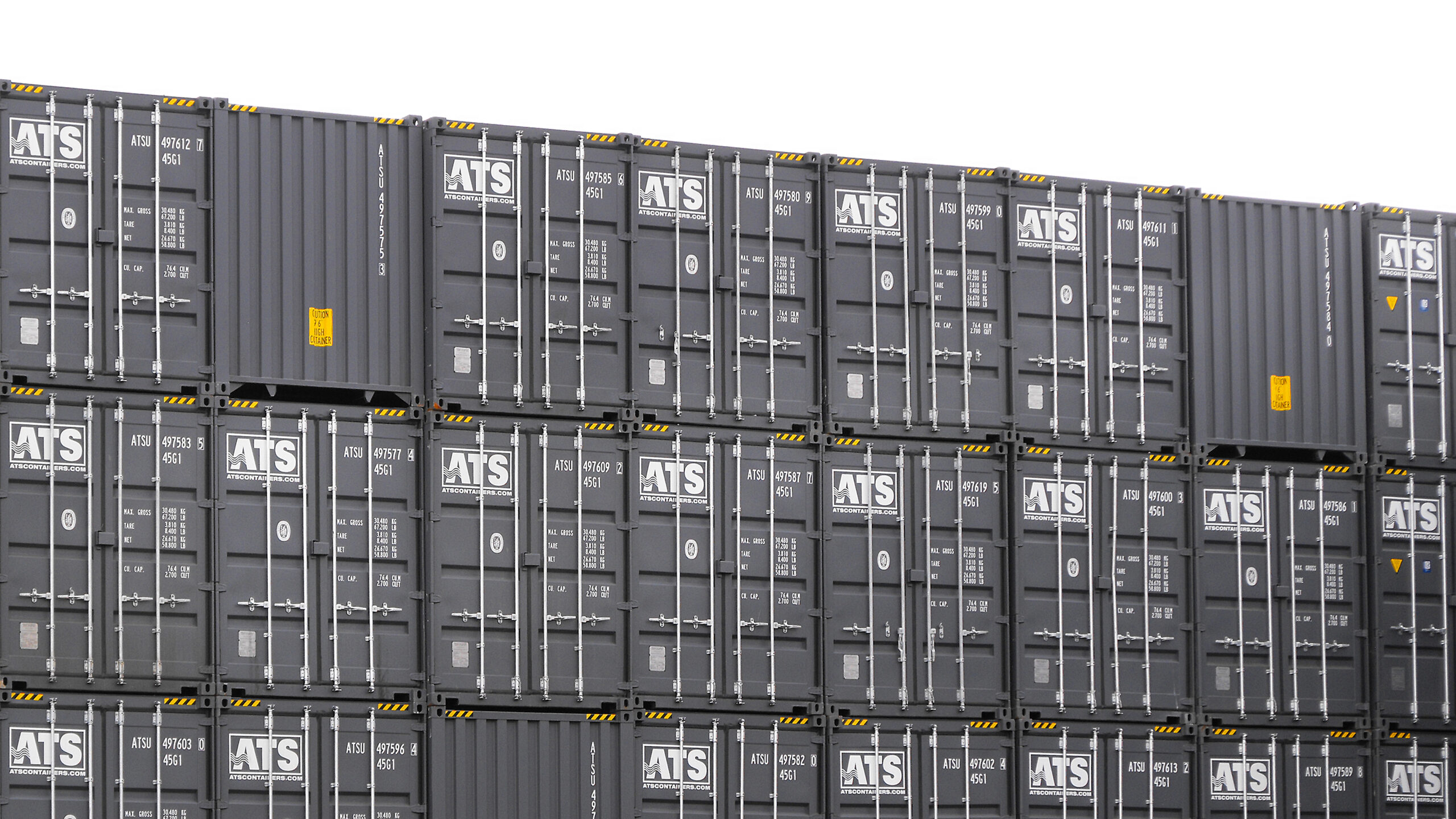 Conteneur maritime neuf de 20 pieds gris, empilé dans notre cour au Québec, prêt pour la vente et la livraison.