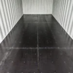 Interior close-up of corrugated steel walls and floor inside a 20-ft container