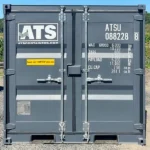 Rear view of a mini 8-ft new shipping container with doors closed