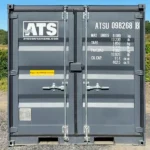 Rear view of a new mini 9-ft shipping container with doors closed