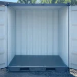 Rear view with doors open, showing the clean interior of a new mini 9-ft storage container