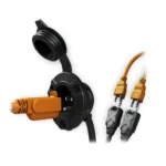 Open NOCO AC inlet power port accepting a standard plug, dual-outlet splitter powering tools inside a shipping container, ATS Containers.