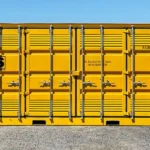 Front view of a 20ft yellow dangerous goods container with ATS logo, multiple locking bars, and ventilation panels.