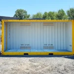 Dangerous goods container with both end doors fully open, showing the grated floor and internal bund capacity markings.