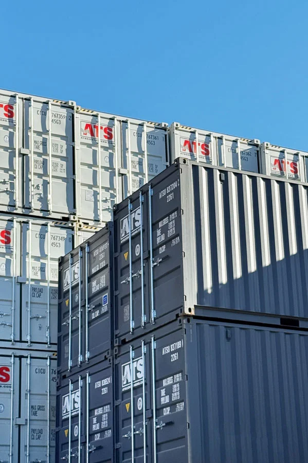 Pristine new one-trip 20ft shipping containers in light gray and dark gray finish, showcasing the lack of rust, dents, or floor wear typical of new units in Canada. New (One-Trip) Containers: Pristine condition units that offer the best long-term value, aesthetics, and structural durability.A guide to new "one-trip" shipping container pricing in Canada for 2026. Factors impacting costs include factory-direct manufacturing prices, ocean freight volatility from Asia, and the current cost of marine-grade Corten steel. Ideal for retail storefronts, high-end modular builds, and long-term sensitive storage.