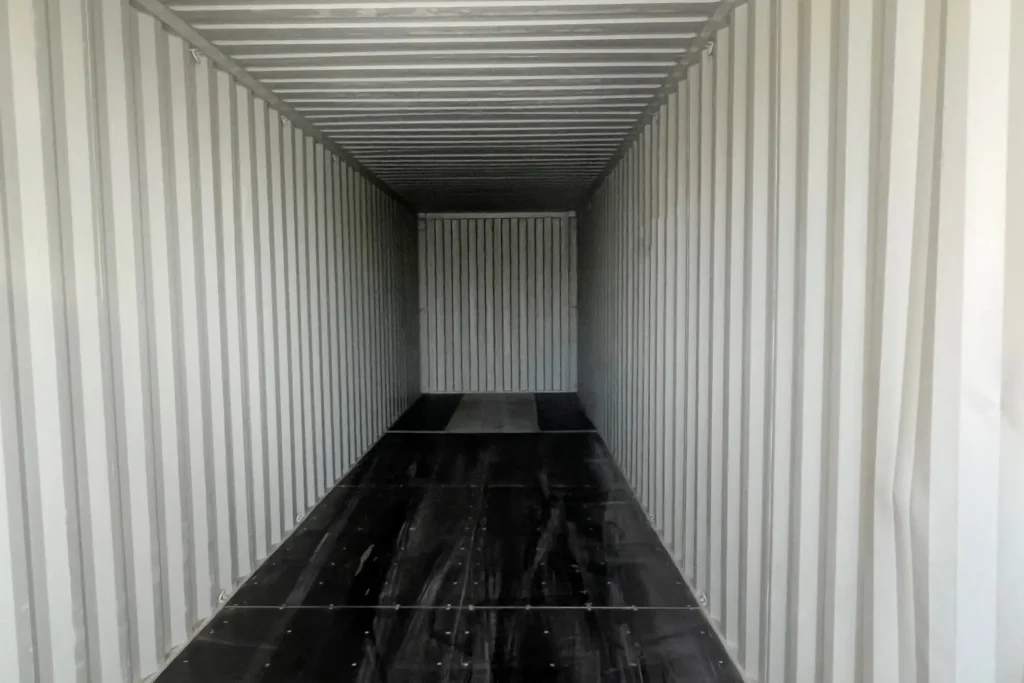 High-quality marine-grade plywood flooring inside a new 40ft sea can for Edmonton industrial use.