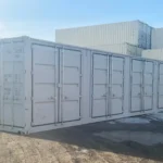 Exterior view of a new 40ft High Cube side-opening container showing four closed side doors and standard end cargo doors on a gravel lot.