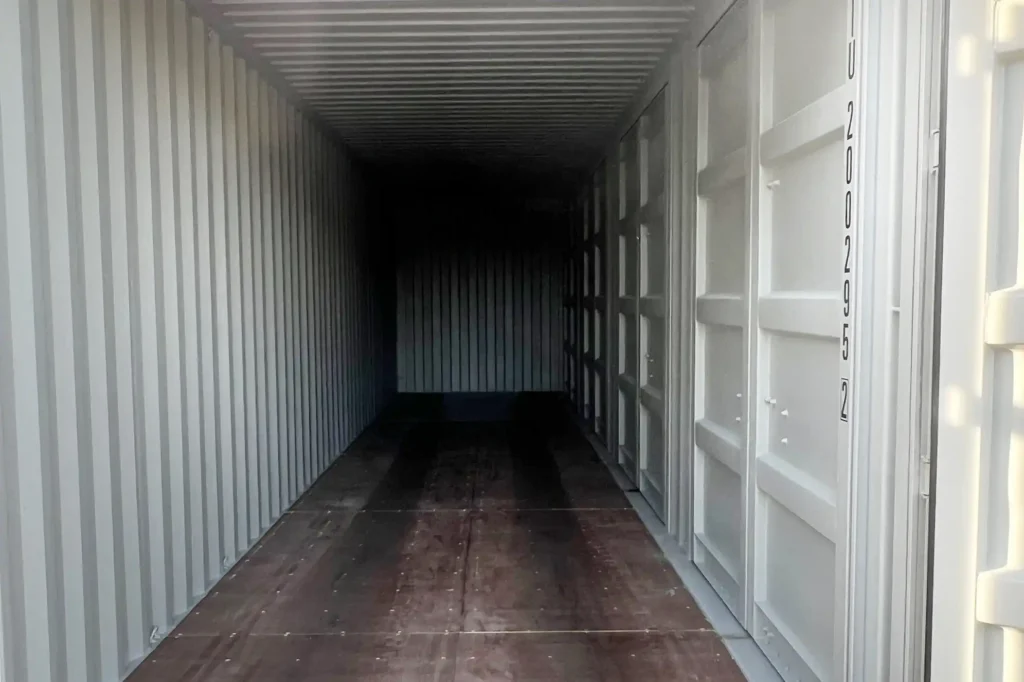 Interior perspective of a 40ft side-opening container highlighting the marine-grade hardwood flooring and the structural locking bars of the side doors.