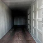 Interior perspective of a 40ft side-opening container highlighting the marine-grade hardwood flooring and the structural locking bars of the side doors.