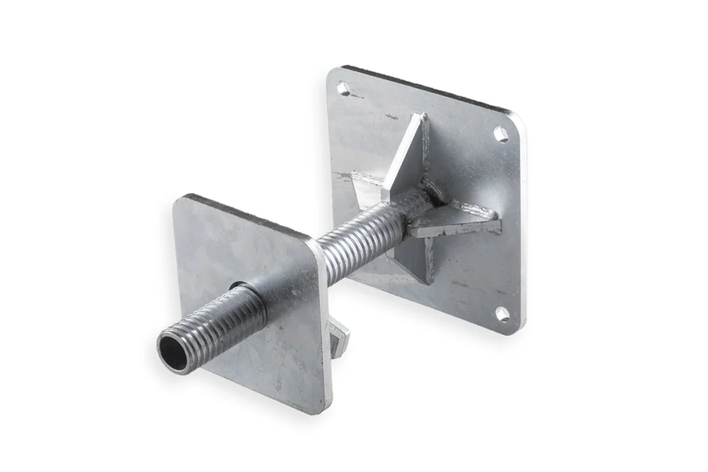 Detail view of the four-hole steel baseplate on a container leveling leg, designed for standard ground anchors.