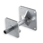 Detail view of the four-hole steel baseplate on a container leveling leg, designed for standard ground anchors.