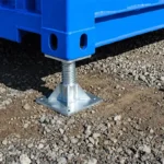 Close-up showing a steel leveling jack securely fitted into the bottom corner casting of a shipping container.