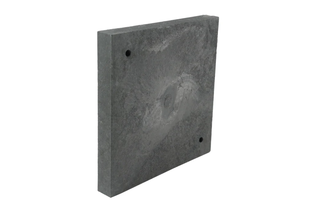 Angled view of a single weatherproof shipping container leveling block resting on a flat surface.