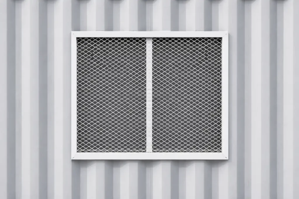 Protective window grill installed on a Job Box container