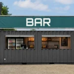 Bar kiosque en conteneur noir avec grande ouverture de service et enseigne BAR au-dessus du comptoir
