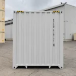 Closed end view of a light grey 40 ft high cube side door shipping container in a container yard