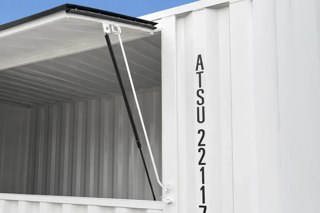 Close-up of flip-up serving window with gas spring strut on event container open