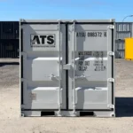 Front view of ATS 9 ft office container with cargo doors and ATS logo