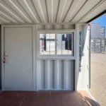 Interior view of 9 ft office container with entry door and sliding window